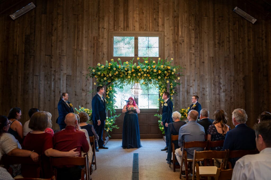 Erik and Tim exchanging vows during their gay wedding ceremony at Oak Farm Vineyards in Lodi, CA