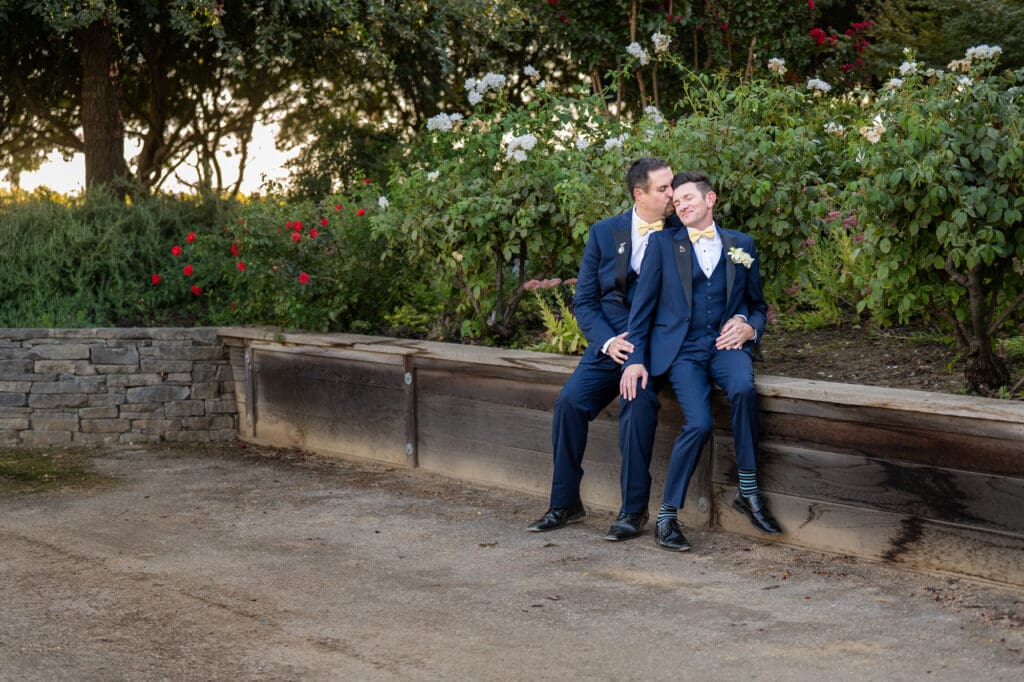 two grooms cuddling during wedding day