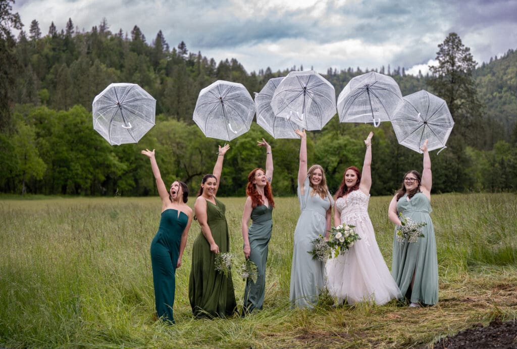 bridesmaids tossing clear umbrellas into the air