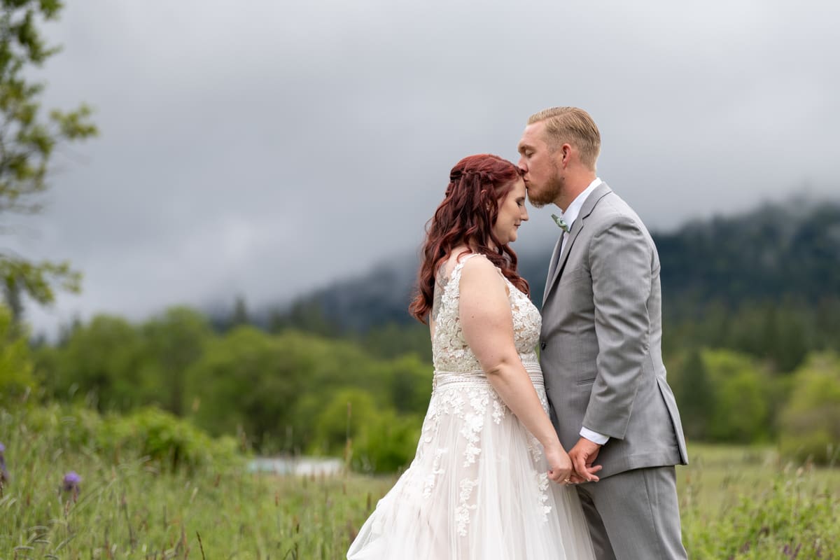 bride and groom at applegate ranch during rainy day
