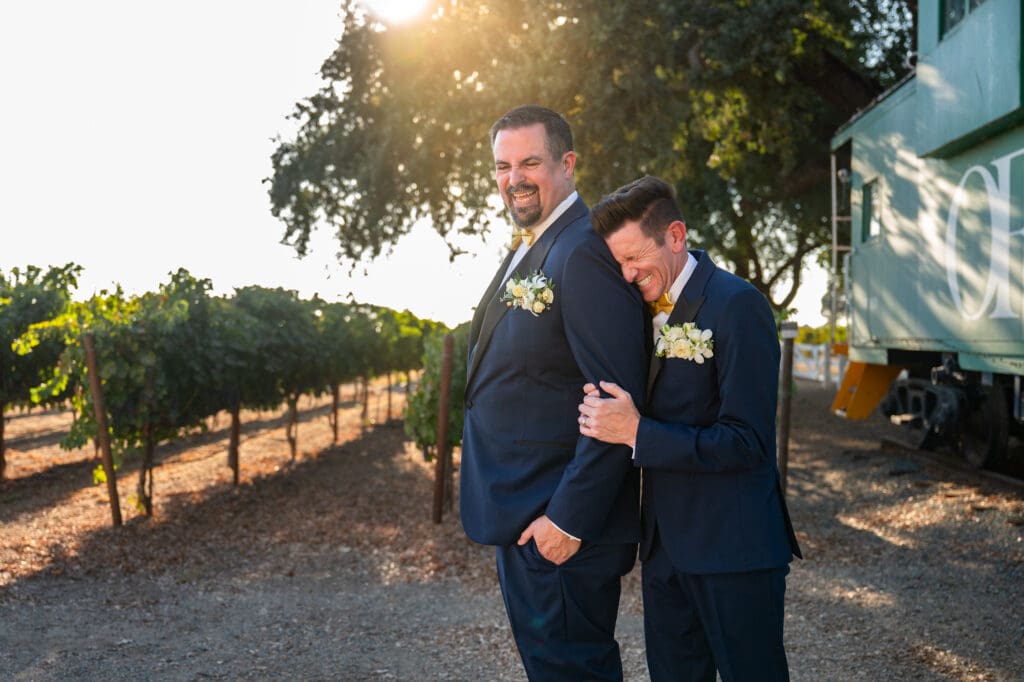 candid wedding photo of grooms laughing