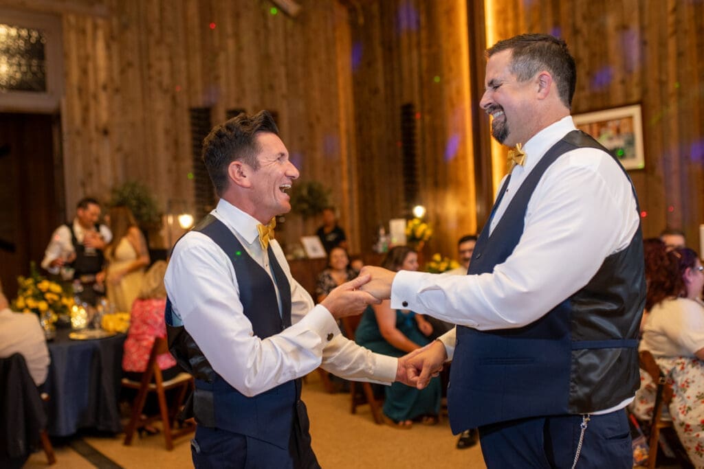 married gay couple dancing at reception