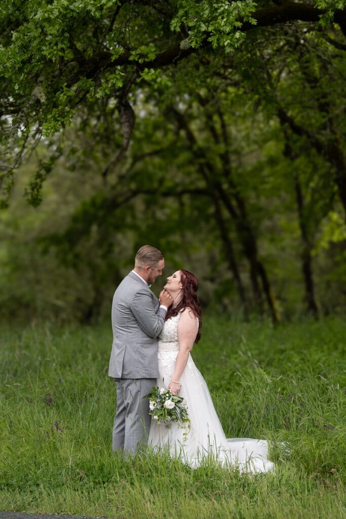 bride and groom under trees