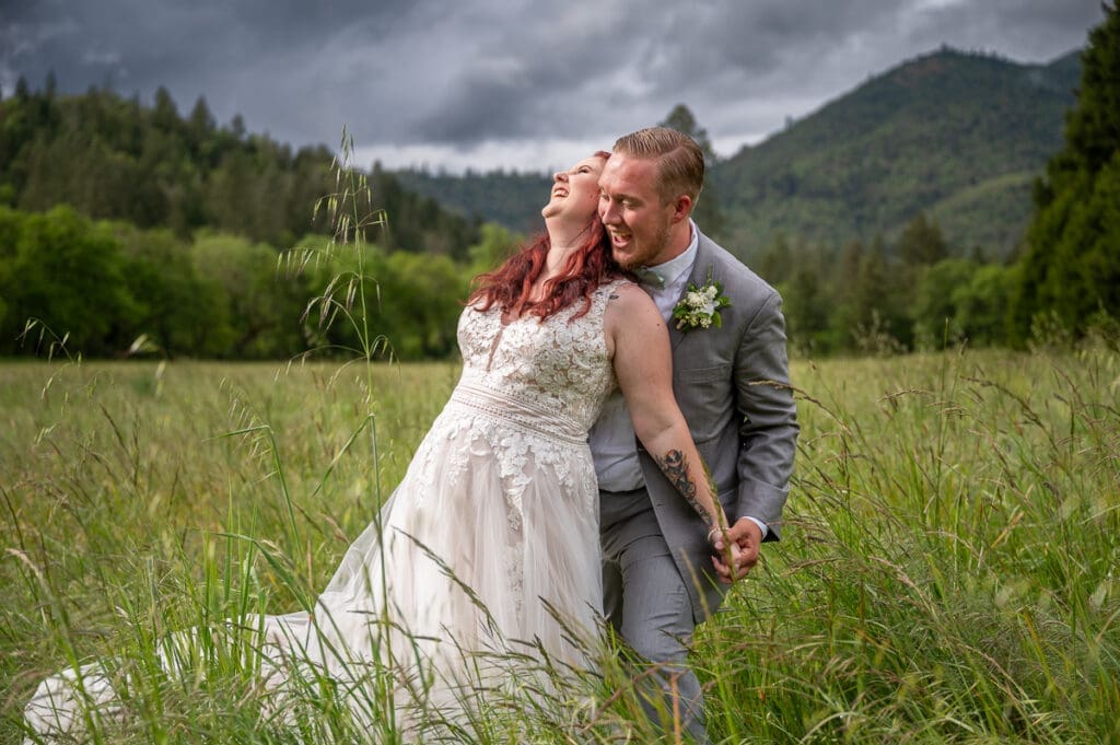 bride and groom laughing and playing