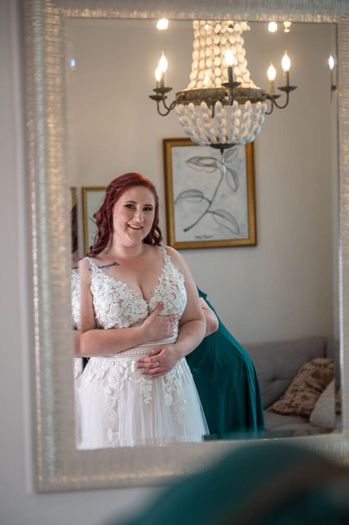 bride getting ready in full length mirror